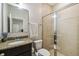 Bathroom featuring a granite vanity, toilet, mirror and glass enclosed tile shower at 1816 Forest Glen Dr, Fruitland Park, FL 34731