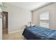Cozy bedroom with tiled floors, neutral walls, and natural light from a window at 1816 Forest Glen Dr, Fruitland Park, FL 34731