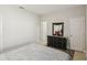Neutral bedroom featuring a queen sized bed, dresser, and a door to the en suite bath at 1816 Forest Glen Dr, Fruitland Park, FL 34731