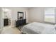 Bright bedroom featuring a dresser with mirror and ensuite bathroom at 1816 Forest Glen Dr, Fruitland Park, FL 34731