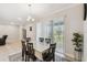 Bright dining area featuring a table with six chairs and sliding doors to the backyard at 1816 Forest Glen Dr, Fruitland Park, FL 34731