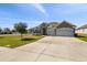 Charming single-story home featuring a stone facade, two-car garage, and a well-manicured front lawn at 1816 Forest Glen Dr, Fruitland Park, FL 34731