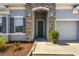Welcoming front entrance features stone accents, manicured landscaping, and a charming doorway at 1816 Forest Glen Dr, Fruitland Park, FL 34731