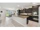 A spacious kitchen features dark cabinets, granite countertops, stainless steel appliances, and a large island at 1816 Forest Glen Dr, Fruitland Park, FL 34731