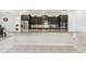 Bright kitchen featuring a large granite island, stainless steel appliances, and ample cabinet space at 1816 Forest Glen Dr, Fruitland Park, FL 34731