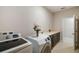 Convenient laundry room with modern washer, dryer, and ample counter space at 1816 Forest Glen Dr, Fruitland Park, FL 34731