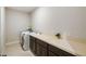 Well-lit laundry room with extensive countertops and modern appliances at 1816 Forest Glen Dr, Fruitland Park, FL 34731