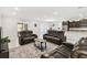 Spacious living room features plush leather seating and neutral decor at 1816 Forest Glen Dr, Fruitland Park, FL 34731