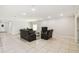 Spacious living room with neutral tones, tile flooring, and comfortable seating arrangement at 1816 Forest Glen Dr, Fruitland Park, FL 34731