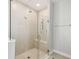 Modern walk-in shower with glass enclosure, rainfall shower head, and built-in bench at 1816 Forest Glen Dr, Fruitland Park, FL 34731