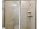 Enclosed tile shower featuring glass door, built-in shelving, and modern fixtures at 1816 Forest Glen Dr, Fruitland Park, FL 34731