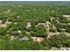 An aerial view of a single Gathering home nestled among mature trees and outbuildings at 18240 Lynbrook Rd, Orlando, FL 32820
