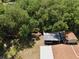 An aerial view of a small cottage nestled among trees and outbuildings at 18240 Lynbrook Rd, Orlando, FL 32820