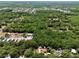 An aerial view showing a single Gathering home with lush trees and greenery at 18240 Lynbrook Rd, Orlando, FL 32820