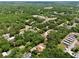 Expansive aerial view of the property surrounded by lush greenery and a serene, quiet neighborhood at 18240 Lynbrook Rd, Orlando, FL 32820