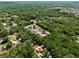 An aerial view showcasing the home among lush greenery in its surroundings at 18240 Lynbrook Rd, Orlando, FL 32820