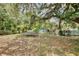 A large trampoline sits in the spacious back yard surrounded by tropical landscaping at 18240 Lynbrook Rd, Orlando, FL 32820