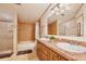 This bathroom features double sinks, tile floors, and a tub with shower at 18240 Lynbrook Rd, Orlando, FL 32820