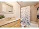 The bathroom features a tiled shower-tub and a light wood vanity at 18240 Lynbrook Rd, Orlando, FL 32820