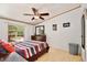 This bedroom is bright with natural light and has wood-look laminate flooring and modern ceiling fan at 18240 Lynbrook Rd, Orlando, FL 32820