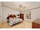 Bright bedroom with laminate flooring and a classic wood bed frame and bedside table at 18240 Lynbrook Rd, Orlando, FL 32820