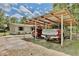 Carport featuring two parked vehicles, with a view of the house at 18240 Lynbrook Rd, Orlando, FL 32820