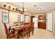 This dining room features a wood table with six chairs and hardwood floors at 18240 Lynbrook Rd, Orlando, FL 32820
