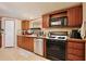 This kitchen features wooden cabinets, stainless steel appliances and light hardwood floors at 18240 Lynbrook Rd, Orlando, FL 32820
