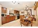This kitchen features wooden cabinets, stainless steel appliances and a dining table at 18240 Lynbrook Rd, Orlando, FL 32820