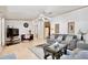 Spacious living room with laminate floors, neutral decor, and view into kitchen at 18240 Lynbrook Rd, Orlando, FL 32820