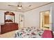 This bedroom features a floral bedspread, hardwood floors, and access to the bathroom at 18240 Lynbrook Rd, Orlando, FL 32820