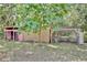 External view of the pink chicken coop, complemented by the green trees surrounding it at 18240 Lynbrook Rd, Orlando, FL 32820