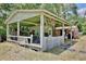 Back outbuilding with covered storage for equipment, surrounded by trees for privacy at 18240 Lynbrook Rd, Orlando, FL 32820
