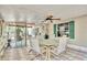 The enclosed patio includes six chairs, a table and a ceiling fan, perfect for outdoor entertaining at 18240 Lynbrook Rd, Orlando, FL 32820