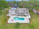 Stunning aerial view of home with pool and white picket fence creating a private backyard oasis at 1901 Lakeshore Cir, Longwood, FL 32750