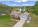 An aerial view showcasing the lovely two-story home, lush greenery, and tranquil lake views at 1901 Lakeshore Cir, Longwood, FL 32750