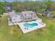 Captivating aerial shot showcasing a pool and solar panels atop this beautiful two-story home at 1901 Lakeshore Cir, Longwood, FL 32750