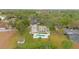 A gorgeous home with a tranquil backyard pool surrounded by lush greenery and mature trees at 1901 Lakeshore Cir, Longwood, FL 32750