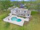 Wonderful aerial view capturing the spacious backyard, refreshing pool, and modern solar panels at 1901 Lakeshore Cir, Longwood, FL 32750