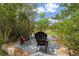 Inviting backyard deck featuring two Adirondack chairs overlooking a serene pond with lush greenery at 1901 Lakeshore Cir, Longwood, FL 32750