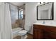Bathroom featuring tiled shower and floors, a vanity, and framed mirror at 1901 Lakeshore Cir, Longwood, FL 32750