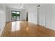 Bright bedroom with hardwood floors, ceiling fan, and sliding glass doors leading to a bathroom at 1901 Lakeshore Cir, Longwood, FL 32750