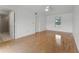 Bright bedroom with ensuite bathroom featuring hardwood floors and a large window at 1901 Lakeshore Cir, Longwood, FL 32750