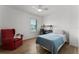 Inviting bedroom with hardwood floors, ceiling fan, desk and red lounge chair at 1901 Lakeshore Cir, Longwood, FL 32750