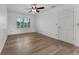 Inviting bedroom featuring plantation shutters, neutral walls, and wood-look flooring at 1901 Lakeshore Cir, Longwood, FL 32750