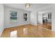 Bright and airy bedroom with hardwood floors and a view to an adjacent room at 1901 Lakeshore Cir, Longwood, FL 32750