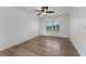 Bright bedroom with hardwood floors and a large window overlooking a lake at 1901 Lakeshore Cir, Longwood, FL 32750