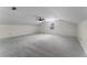 Large bonus room featuring neutral carpet, sloped ceilings, and a window for natural light at 1901 Lakeshore Cir, Longwood, FL 32750