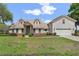 Charming two-story home with attached two-car garage, light-colored siding, and inviting front entrance at 1901 Lakeshore Cir, Longwood, FL 32750