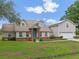 Charming two-story home with attached two-car garage, light-colored siding, and blue front door at 1901 Lakeshore Cir, Longwood, FL 32750